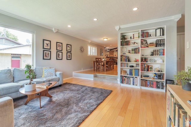 1737 N Sego Ln, Provo, UT 84604 - living room with crown molding, light hardwood / wood-style flooring, built in shelves, and a textured ceiling