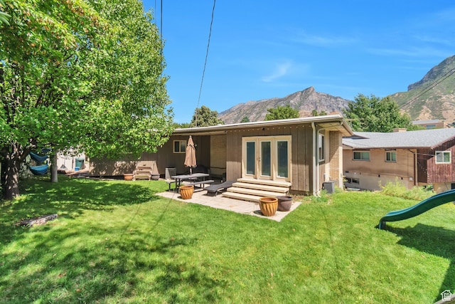 1737 N Sego Ln, Provo, UT 84604 - back of house featuring central AC, a mountain view, a patio area, and a lawn