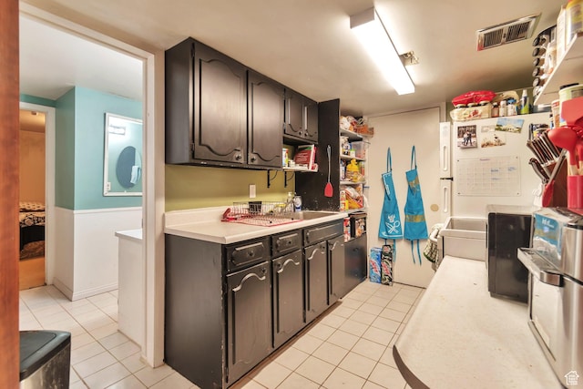 1737 N Sego Ln, Provo, UT 84604 - kitchen with dark brown cabinetry and light tile patterned flooring