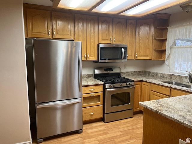 334 S Lariat Way, Grantsville, UT 84029 - kitchen featuring open shelves, a sink, light wood-style flooring, appliances with stainless steel finishes, and light stone countertops