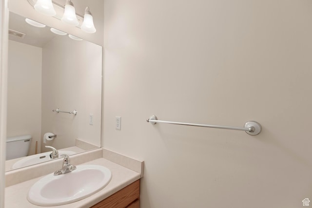 334 S Lariat Way, Grantsville, UT 84029 - bathroom featuring toilet, vanity, and visible vents