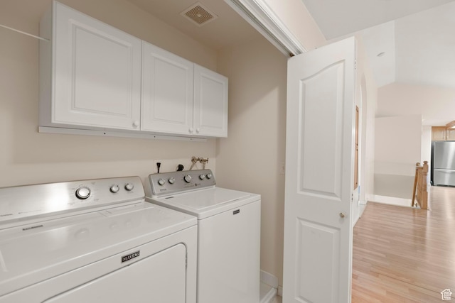 334 S Lariat Way, Grantsville, UT 84029 - laundry room with visible vents, light wood-style floors, washing machine and clothes dryer, baseboards, and cabinet space