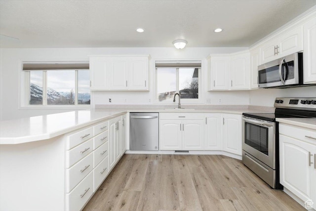 kitchen featuring white cabinetry, sink, and stainless steel appliances
