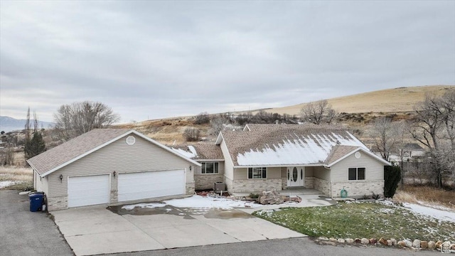 single story home featuring a mountain view and a garage