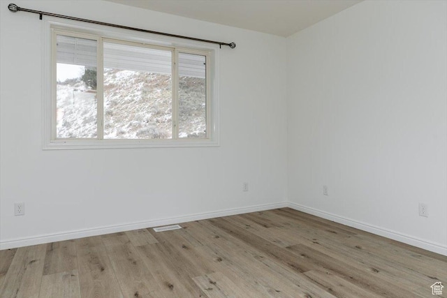 spare room with light hardwood / wood-style flooring