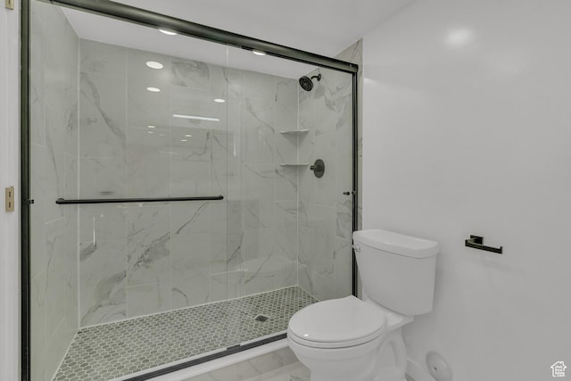 bathroom featuring an enclosed shower and toilet