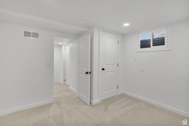 basement featuring light colored carpet
