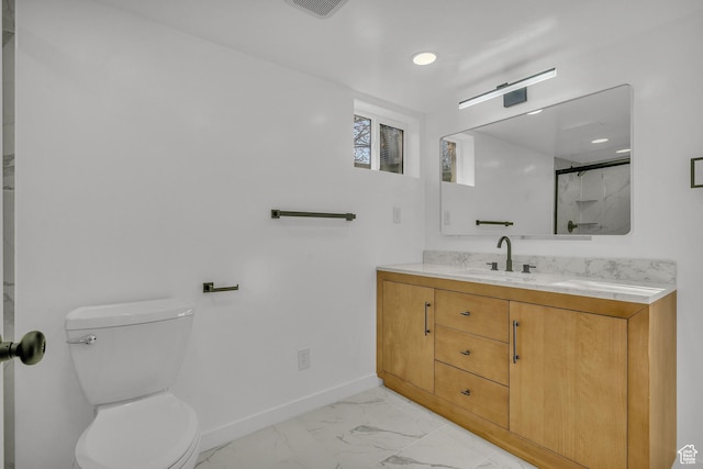 bathroom featuring vanity, walk in shower, and toilet
