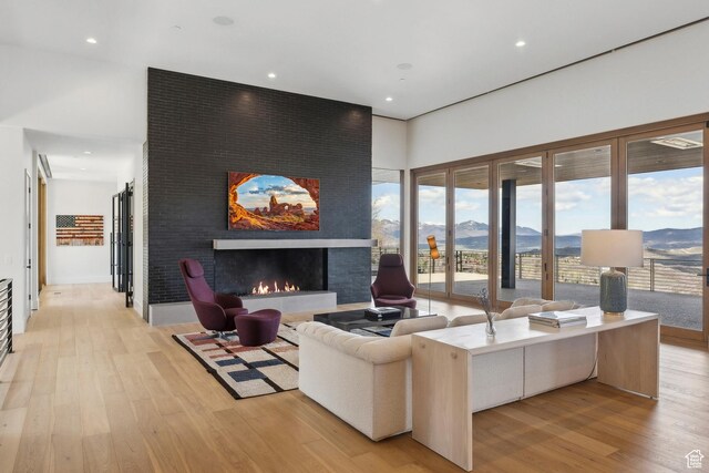 8195 N Ranch Garden Rd, Park City, UT 84098 - living room with light wood-type flooring, a mountain view, a large fireplace, and recessed lighting