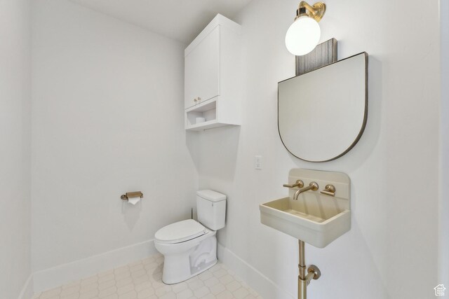 8195 N Ranch Garden Rd, Park City, UT 84098 - bathroom with toilet, baseboards, and a sink