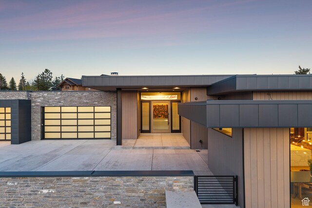 8195 N Ranch Garden Rd, Park City, UT 84098 - modern home featuring an attached garage, driveway, and stone siding