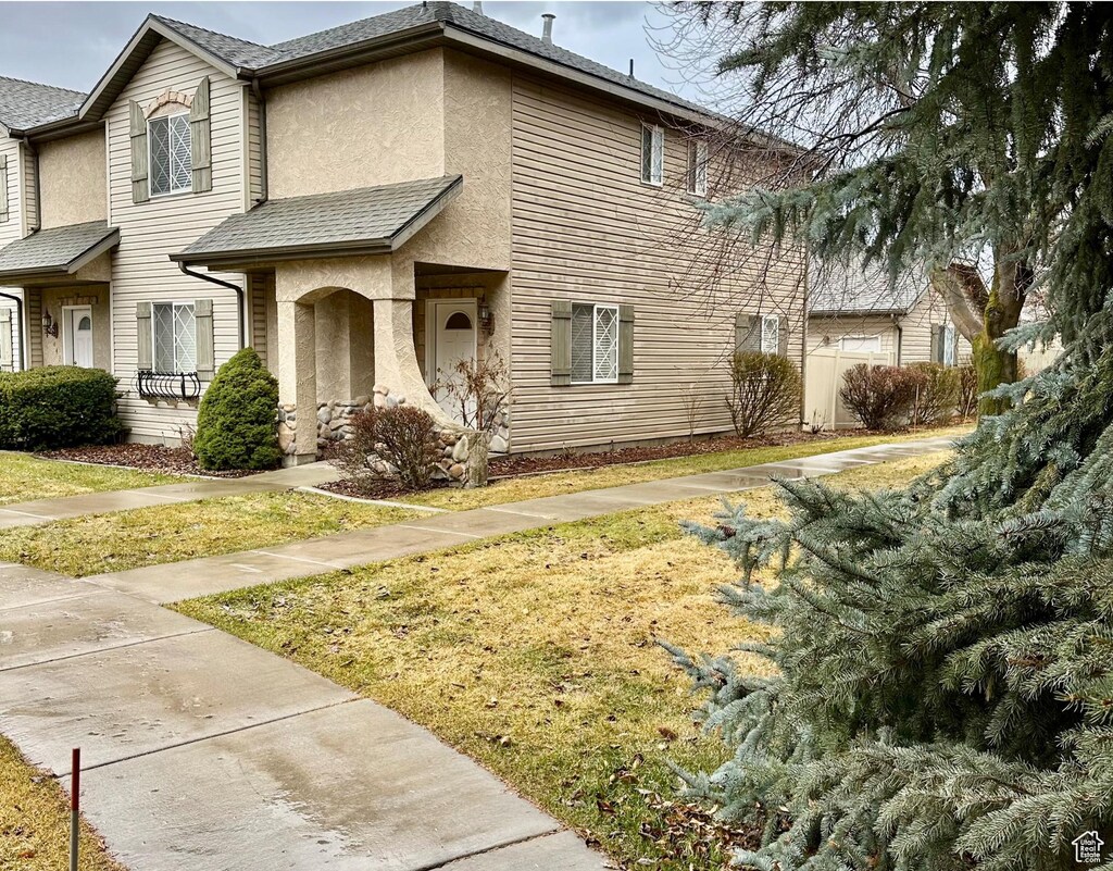 445 W Cobblestone N, Providence, UT 84332 - view of front facade with stucco siding and a front yard