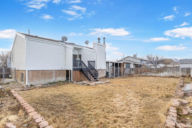 6374 W 3100 S, West Valley City, UT 84128 - rear view of house featuring a lawn