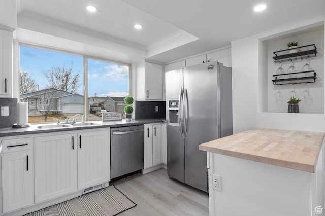 6374 W 3100 S, West Valley City, UT 84128 - kitchen with sink, crown molding, light wood-type flooring, appliances with stainless steel finishes, and white cabinets
