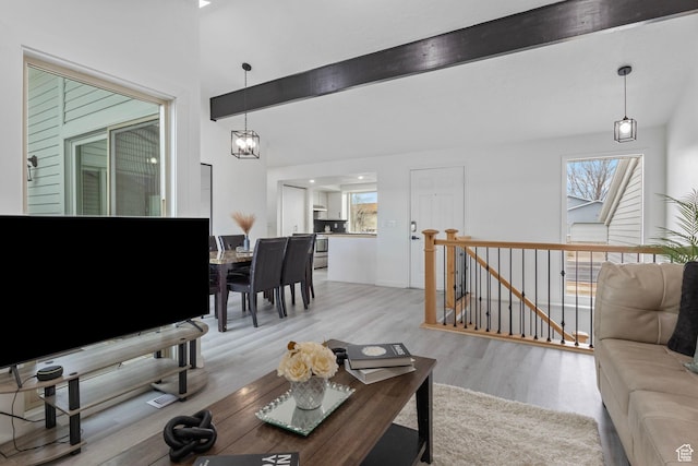 6374 W 3100 S, West Valley City, UT 84128 - living room featuring vaulted ceiling with beams, an inviting chandelier, light hardwood / wood-style floors, and a wealth of natural light