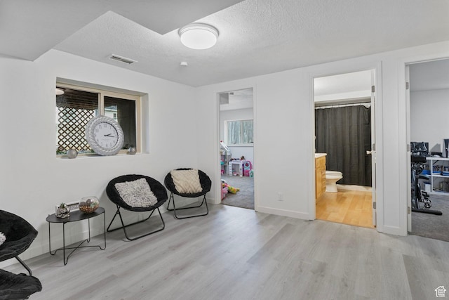 6374 W 3100 S, West Valley City, UT 84128 - sitting room featuring light hardwood / wood-style floors and a textured ceiling