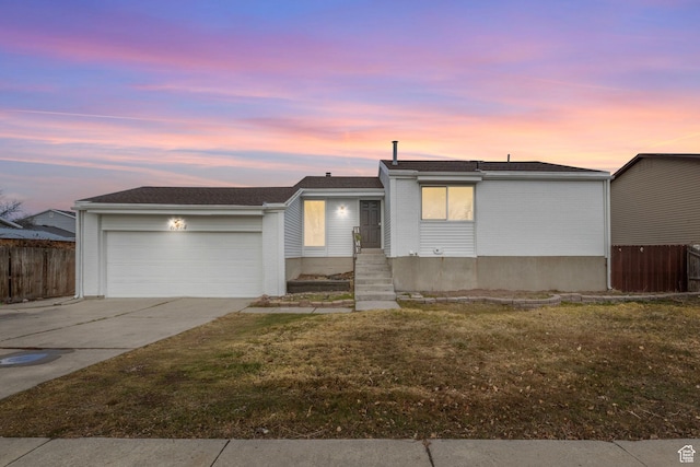 6374 W 3100 S, West Valley City, UT 84128 - view of front of house featuring a garage and a lawn
