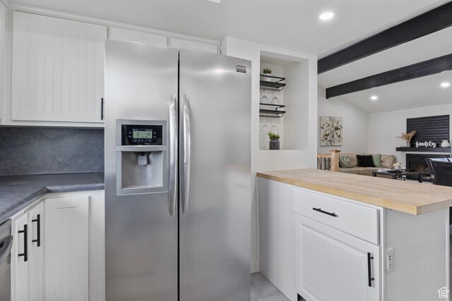 6374 W 3100 S, West Valley City, UT 84128 - kitchen featuring stainless steel appliances, beam ceiling, butcher block countertops, and white cabinets
