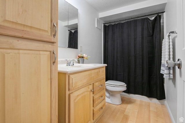6374 W 3100 S, West Valley City, UT 84128 - bathroom featuring walk in shower, toilet, a textured ceiling, vanity, and hardwood / wood-style floors