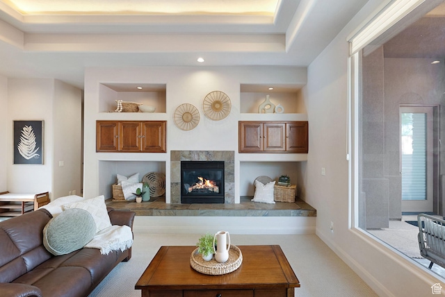 2085 N Tuweap Unit 52, St George, UT 84770 - living room featuring a tray ceiling, a tile fireplace, and carpet flooring