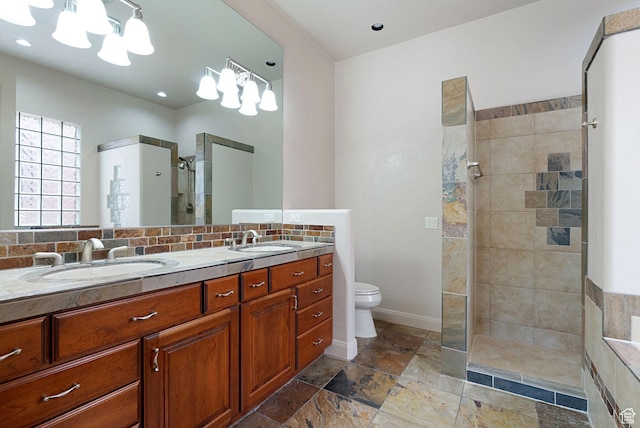 2085 N Tuweap Unit 52, St George, UT 84770 - bathroom featuring tiled shower, vanity, toilet, and decorative backsplash