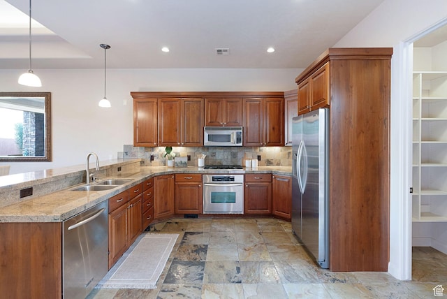 2085 N Tuweap Unit 52, St George, UT 84770 - kitchen featuring decorative light fixtures, sink, backsplash, light stone counters, and stainless steel appliances
