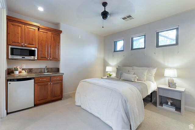 2085 N Tuweap Unit 52, St George, UT 84770 - carpeted bedroom with fridge and ceiling fan