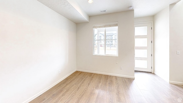unfurnished room featuring light wood-type flooring