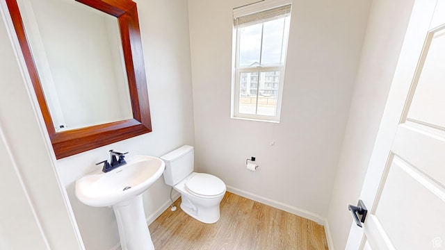 bathroom featuring hardwood / wood-style floors and toilet