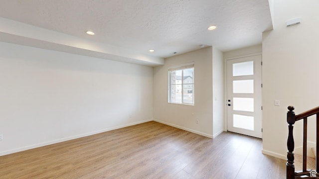 foyer featuring light hardwood / wood-style flooring and a textured ceiling