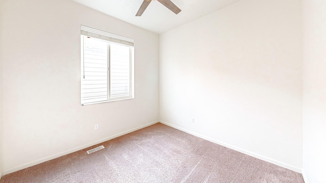 spare room featuring ceiling fan and carpet flooring
