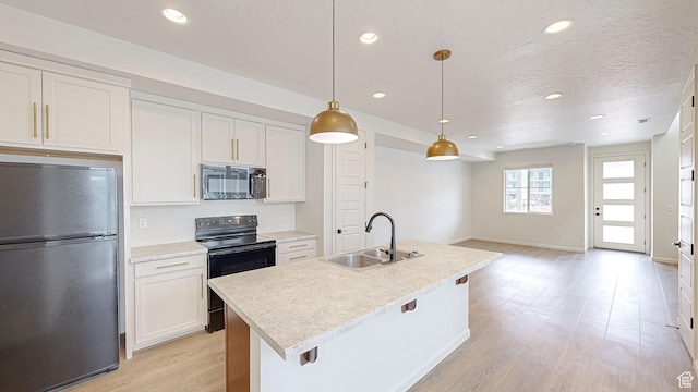 kitchen with sink, decorative light fixtures, black appliances, and white cabinets