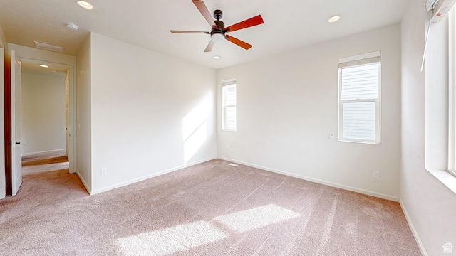 spare room featuring ceiling fan and light colored carpet