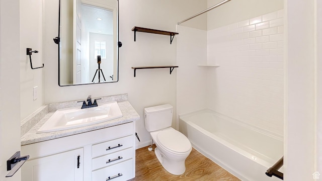 full bathroom with vanity, shower / bathing tub combination, hardwood / wood-style floors, and toilet