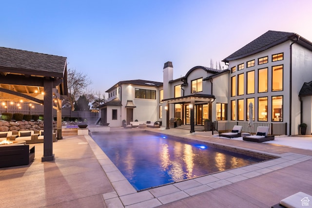 6121 Verness Cv S, Holladay, UT 84121 - pool at dusk featuring an outdoor living space and a patio area