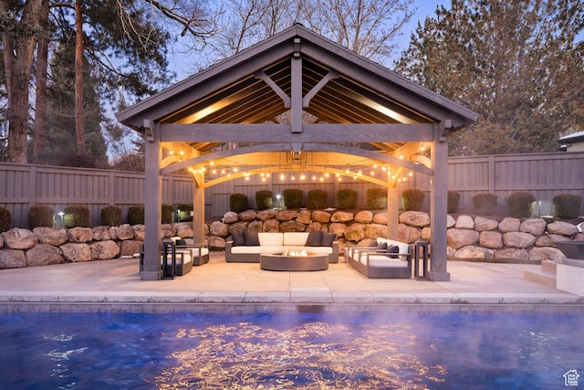 6121 Verness Cv S, Holladay, UT 84121 - pool at dusk with an outdoor living space, a gazebo, and a patio