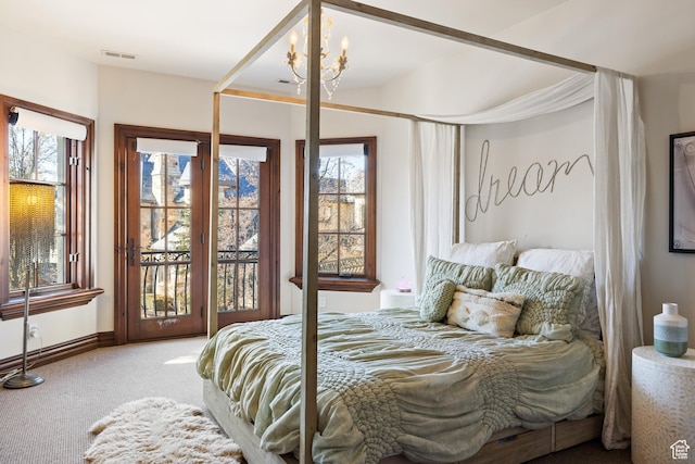 6121 Verness Cv S, Holladay, UT 84121 - carpeted bedroom featuring a chandelier and access to outside