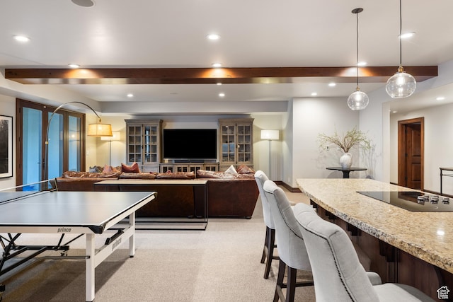 6121 Verness Cv S, Holladay, UT 84121 - kitchen with hanging light fixtures, beam ceiling, light stone countertops, black electric cooktop, and light colored carpet