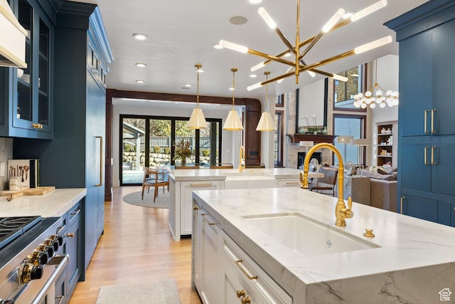 6121 Verness Cv S, Holladay, UT 84121 - kitchen with light stone counters, a large island, hanging light fixtures, and a notable chandelier
