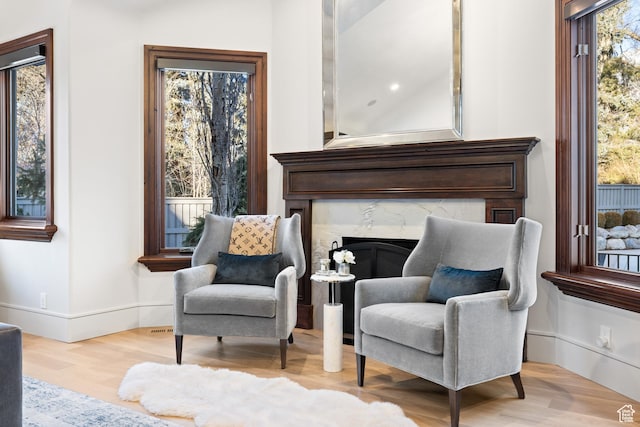 6121 Verness Cv S, Holladay, UT 84121 - sitting room with a fireplace and light hardwood / wood-style floors