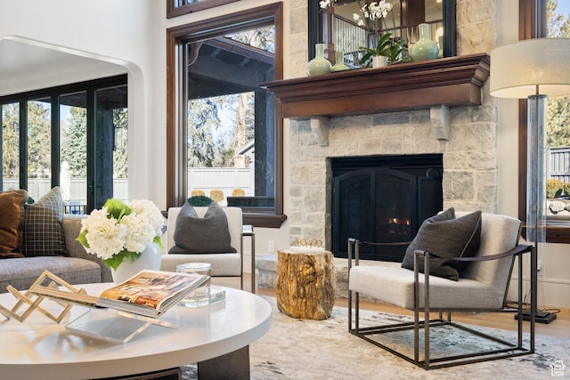 6121 Verness Cv S, Holladay, UT 84121 - sitting room featuring a fireplace, wood-type flooring, and plenty of natural light