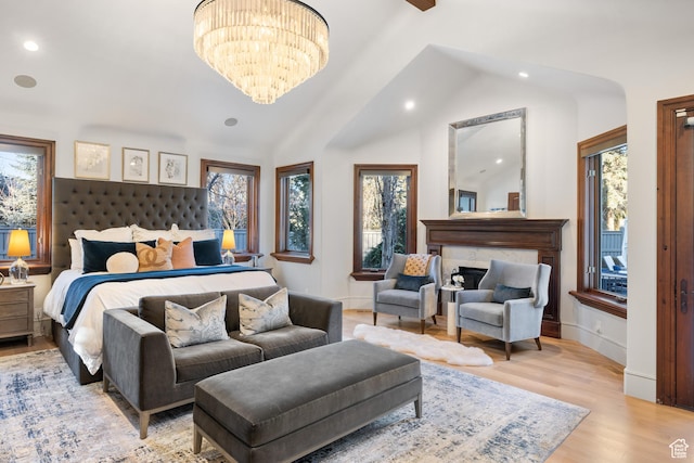 6121 Verness Cv S, Holladay, UT 84121 - bedroom featuring an inviting chandelier, lofted ceiling, multiple windows, and light wood-type flooring