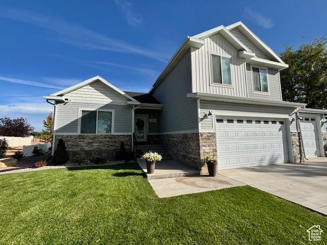 craftsman-style house with a garage and a front lawn