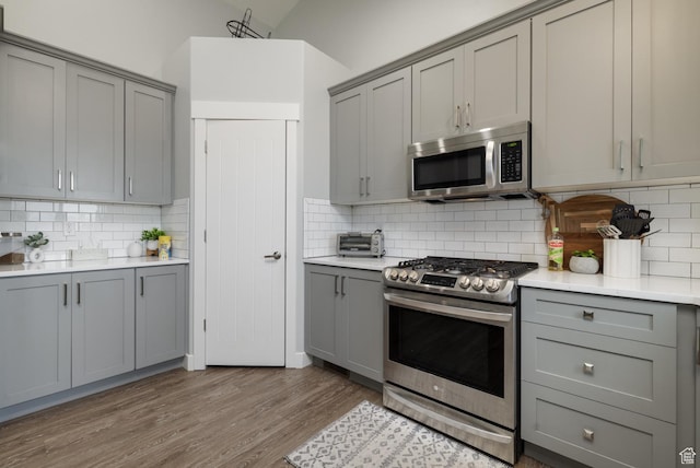 4093 E 4000 S, Vernal, UT 84078 - kitchen with gray cabinetry, decorative backsplash, light hardwood / wood-style flooring, and stainless steel appliances