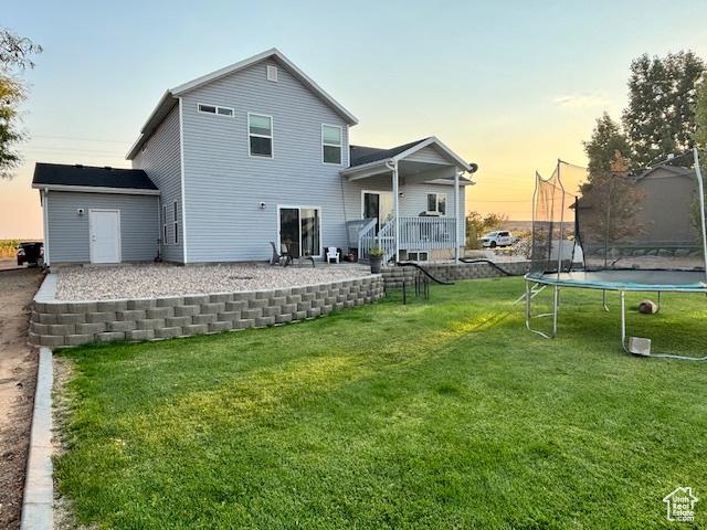 4093 E 4000 S, Vernal, UT 84078 - back house at dusk with a trampoline, a yard, and an outbuilding