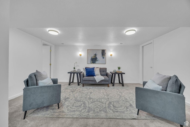 living area featuring baseboards and carpet floors