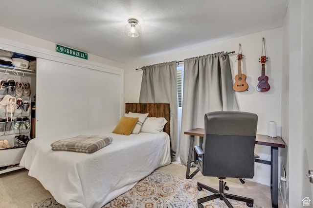 bedroom with light colored carpet and a closet