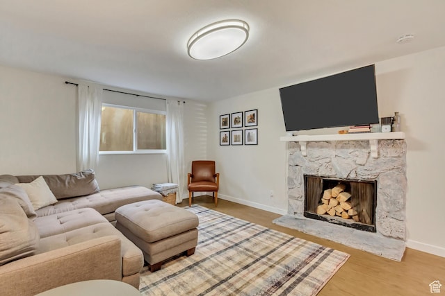 living room with wood-type flooring and a fireplace