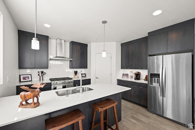 4513 S Bleecker Pl E, Millcreek, UT 84117 - kitchen featuring appliances with stainless steel finishes, decorative light fixtures, sink, and wall chimney exhaust hood