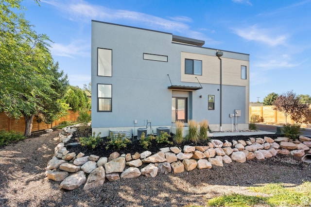 rear view of property with cooling unit